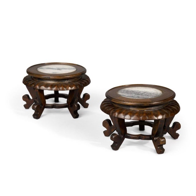 A handsome pair of Chinese marble-inset rosewood stands dating to the 20th century, distinguished by their clean lines,...