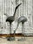 Add a touch of timeless elegance to your home or garden with this charming set of two cast metal crane sculptures. Each...