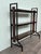 This vintage industrial-style bookcase dates back to the 1970s in Italy. The piece features a geometric black-painted iron...