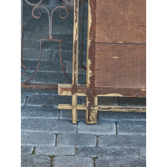 An unusual Tramp Art mirror from circa 1920 with hand-carved gilded frame and intersecting corners. Step into an opulent...