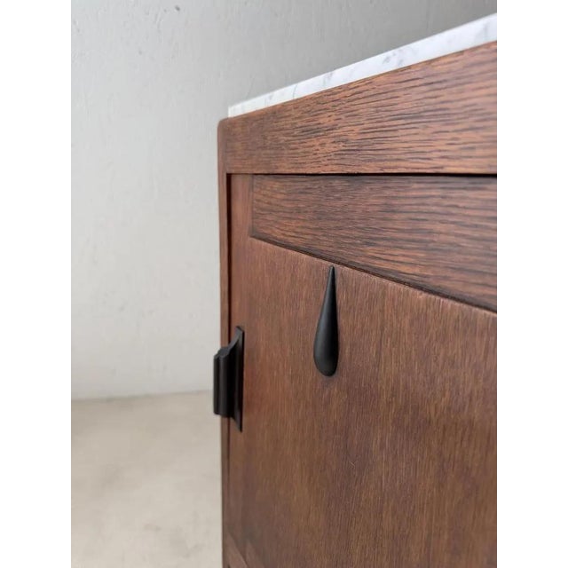 with this cabinet, everything revolves around contrast and detail. The bright white-grey marble top appears to rest almost...