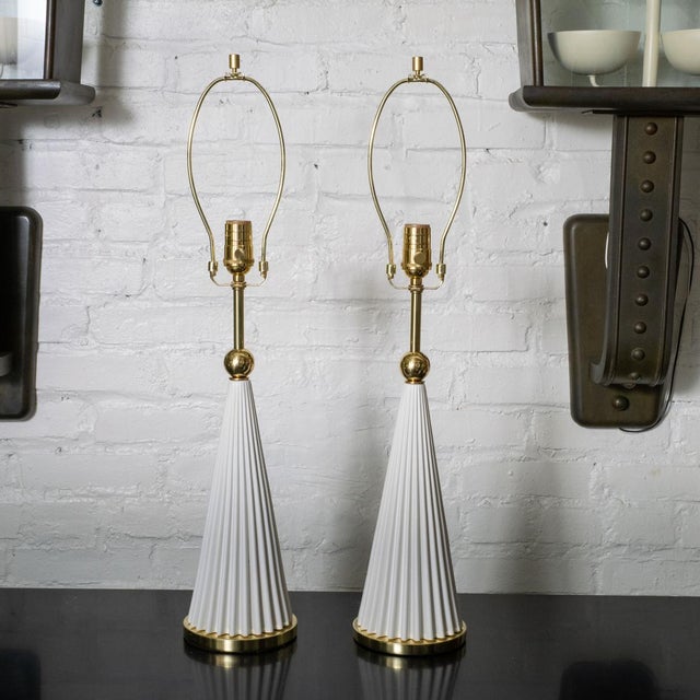 Pair of white painted conical metal table lamps with brass hardware in the style of Gerald Thurston for Lightolier.