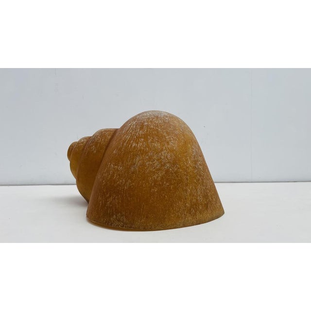 This mid-century style snail sculpture by Camilli Sergio is crafted from semi-transparent fiberglass, embodying the design...