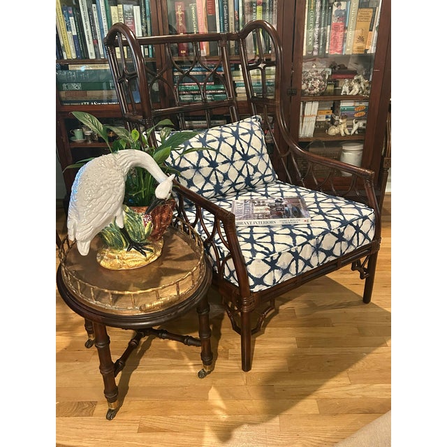 This is a very large chair with chinoiserie flair. The wrapped rattan is constructed in an hour glass design and the...