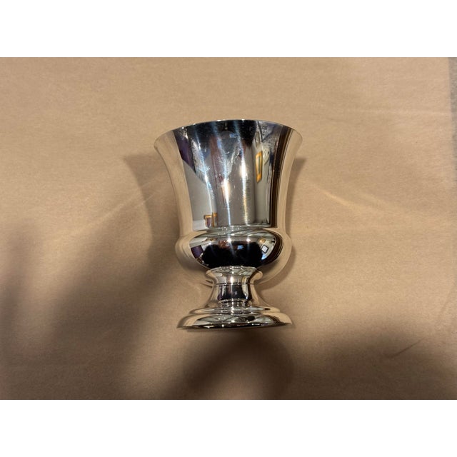 This is a small vintage sterling silver urn cup. It has a pedestal base. It has its sterling mark on the bottom. It is...