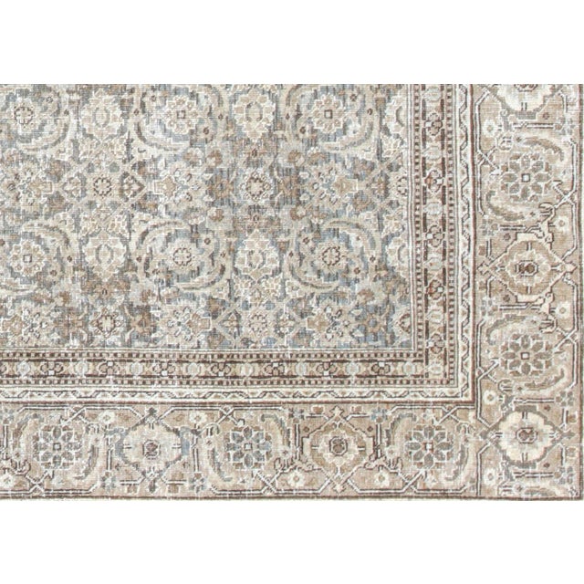 Semi-antique Tabriz rug handwoven in Northern Iran using traditional techniques. Measuring 6'9" x 10', it has been...