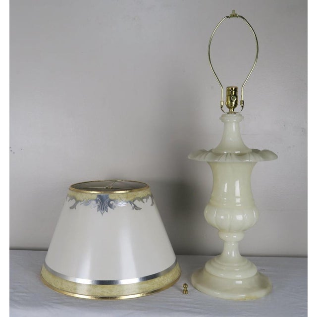 Cream alabaster urn shaped lamps with hand painted parchment shades. The lamps have been newly rewired and crowned with...