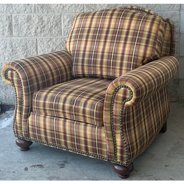 Generously proportioned club chairs by Ethan Allen. Features rolled arms, nailhead trim, tight back and bun feet. Matching...