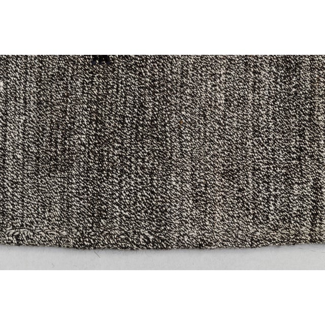 This is a vintage Turkish Oushak rug from the Mid 20th Century. The piece was hand-knotted.
