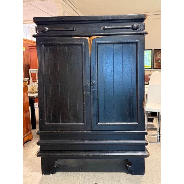 Design Plus Gallery presents a Vintage Asian-Inspired Black Wood Armoire / Storage Cabinet. This substantial wood cabinet...