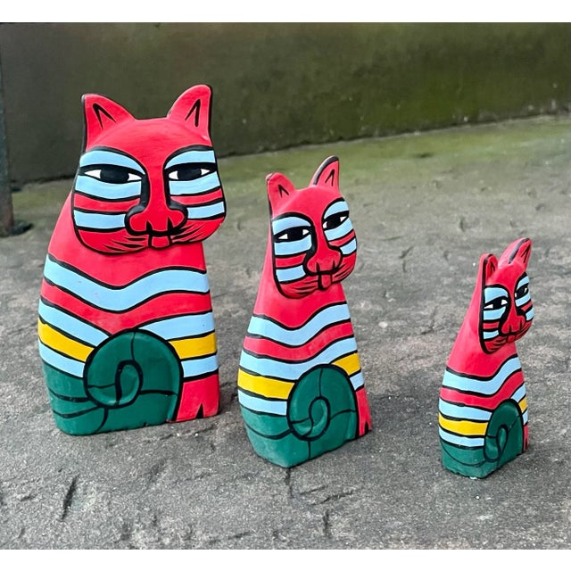 Vintage hand painted trio of wooden folk art cats. Standing at heights of 5, 4 & 3 inches.