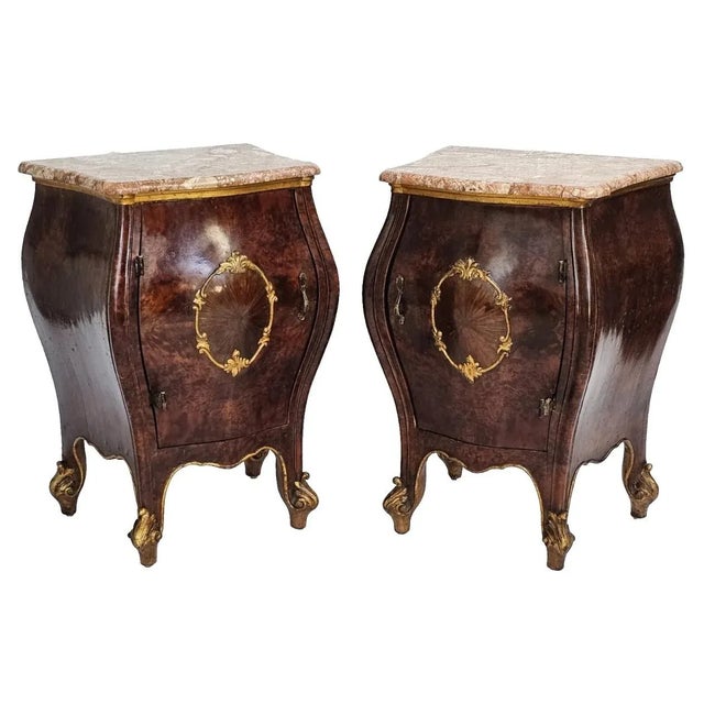 Bring timeless elegance into your space with this exquisite pair of antique Italian bombe nightstands, crafted circa...
