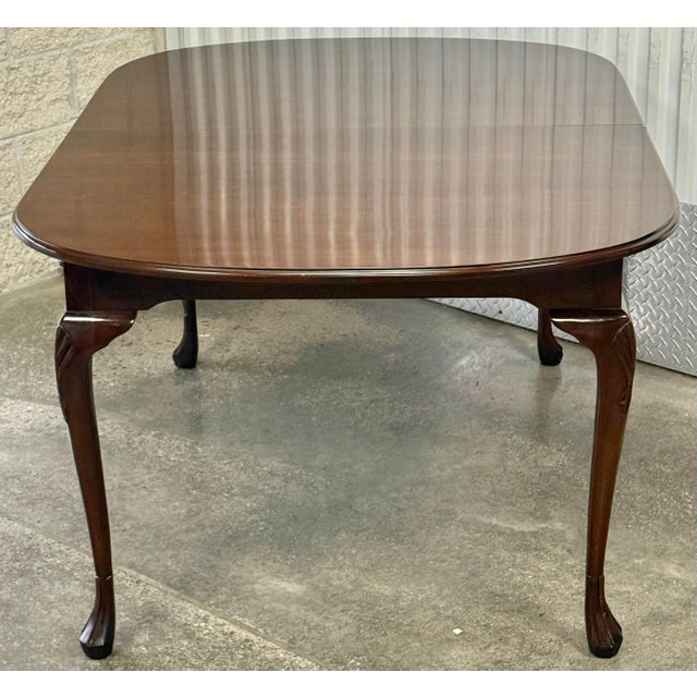 Beautiful and timeless dining table by Harden. Features solid cherry construction, elegant cabriole legs that terminate...