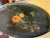 Vintage black tray with painted flowers. Oval in shape with filigree border.