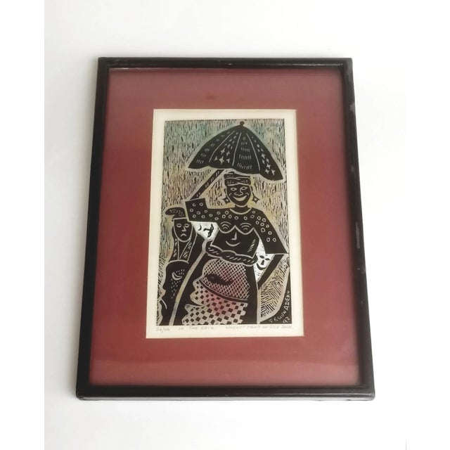 Framed and signed Segun Adeku linocut print on rice paper, "In the Rain" 1992, 24/100. By Nigerian artist, Segun Adeku,...