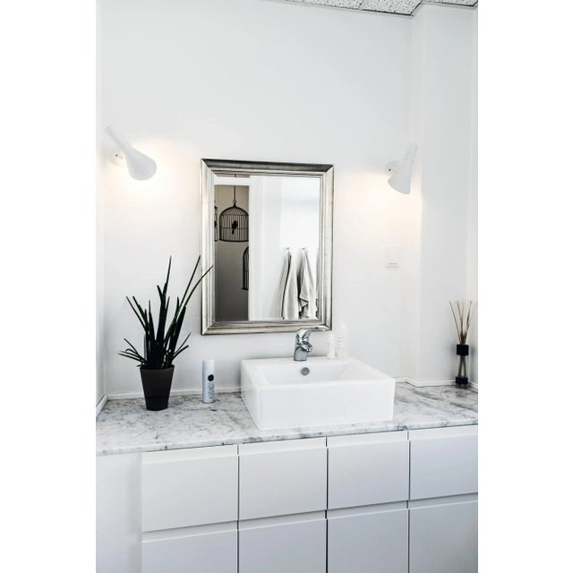 Arne Jacobsen AJ wall light for Louis Poulsen in white. Designed in 1957 among other lighting fixtures for the SAS Royal...