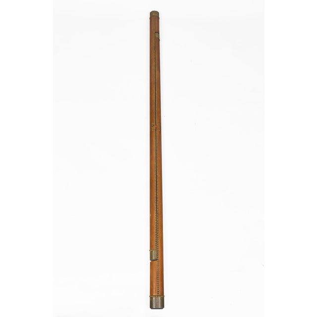 English antique collapsible library pole ladder covered in a luggage-colored leather with evenly spaced brass nail heads....