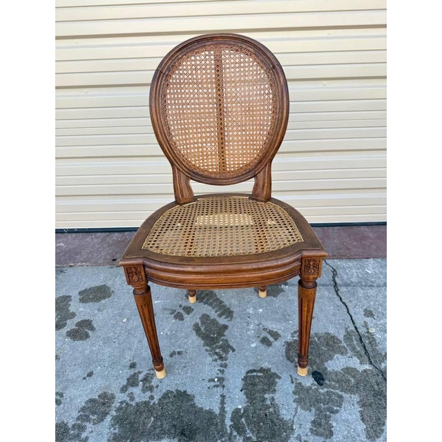 Set of 4 Antique Louis XVI Style Hand Carved Cane Seat Dining chairs Featuring molded medallion contoured backrest frame...