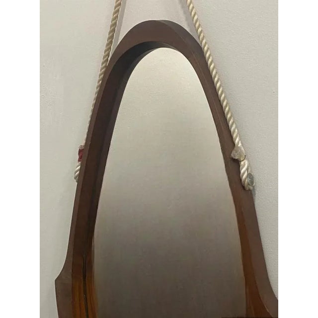TypeShaped wooden mirrorDate1960-69ProvenanceItalyModelRhomboidaleMaterialsRosewood, MirrorWidth 41 cmDepth 4 cmHeight 85 cm