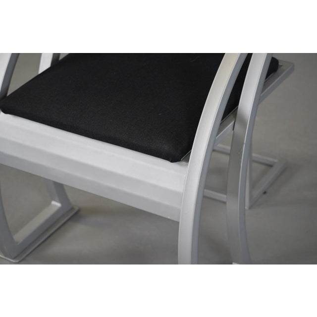 Beautiful designed chair in a minimalist style bended metal and coated metal frame with skai upholstered back and seat.