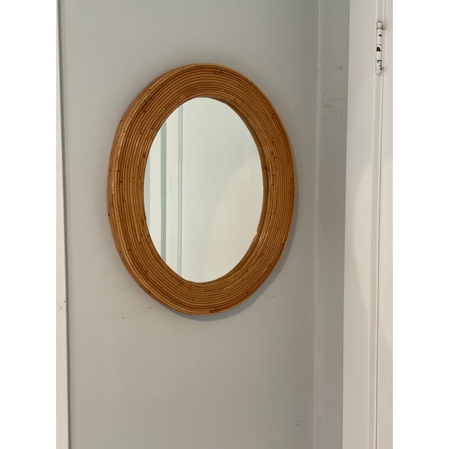 Beautiful simplistic elegance. Palm Regency Crespi style oval Pencil Reed mirror.