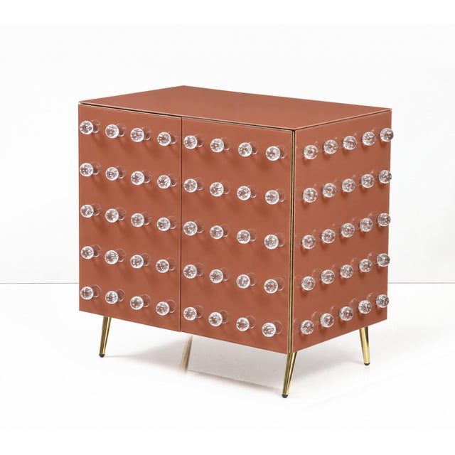 A warm terracotta colour brings a Mediterranean note to this sculptural Italian Murano-glass cabinet. The paired front...