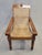 A classic vintage 1990s teak plantation lounge chair with a taught hand-caned seat and backrest. This chair is unique with...