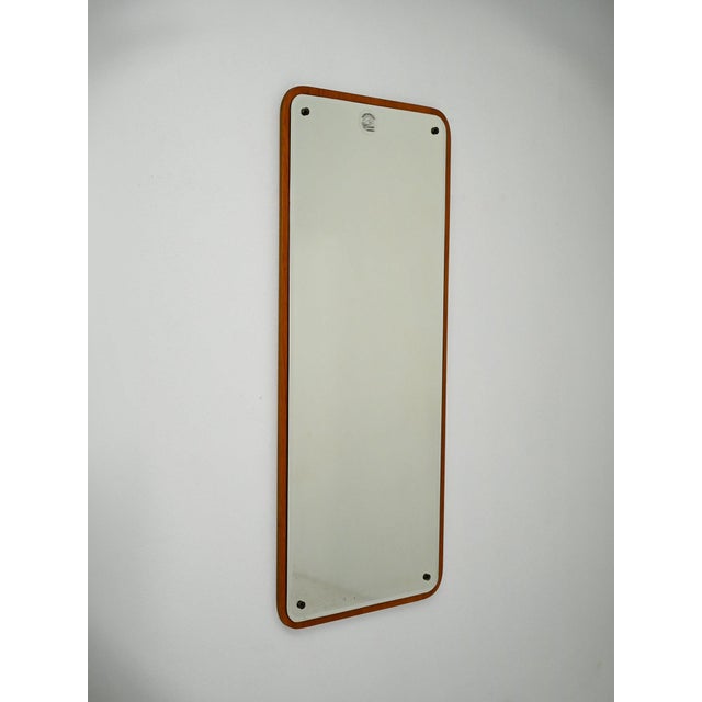 Rectangular Scandinavian mirror with beveled corners, a thin teak frame, and exposed screws. A Scandinavian mirror from...