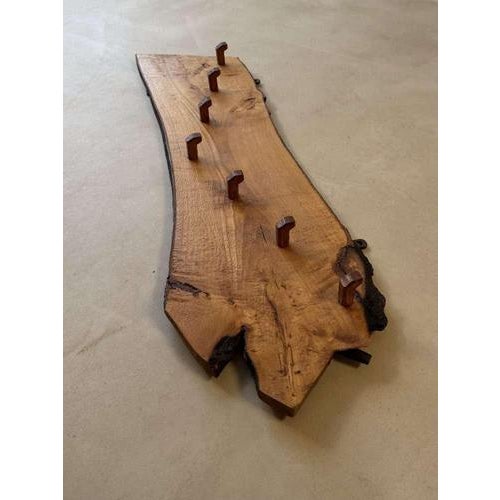 This characterful 1960s coat rack is crafted from a solid tree slab with a distinctive, organic shape. The wood displays a...