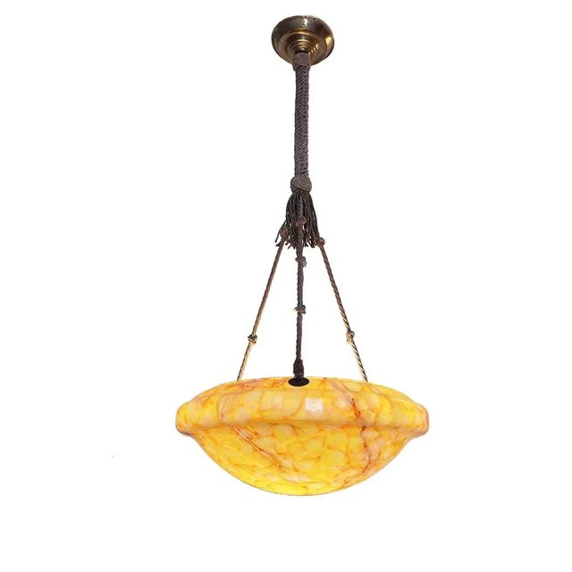 Hand crafted orange, natural white and dark red swirled glass pendant in warm vibrant colours. This glass might have been...