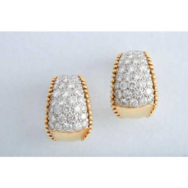 Featuring approximately 5 carats of pave set diamonds mounted in an elegant 18k yellow gold design with beaded edges....
