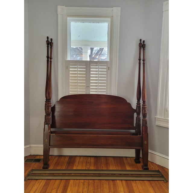 This 1980s Henkel Harris cherry rice bed features fluting and intricate carvings on the posts. It has two sets of slots...