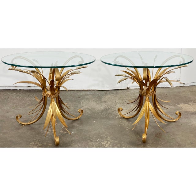 Dress to impress with these statement Italian mid century Hollywood Regency gilt metal sheaf of wheat side tables in the...