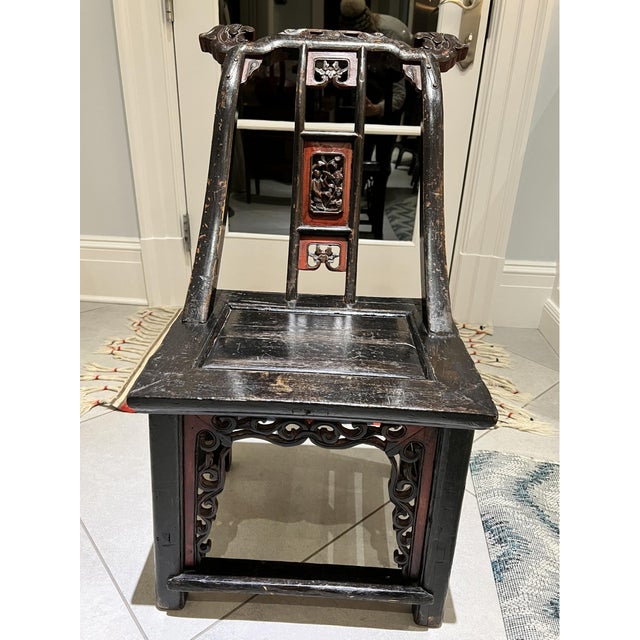 A 19th century hand-carved Chinese side chair with decorative carvings on the backrest, apron and stiles. Product...