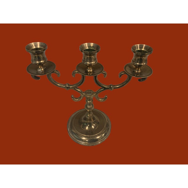 A solid brass candelabra. Holds three candles. A stunner for any table.