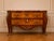 This elegant early 1900s French Louis XVI–style commode combines warm fruitwood, delicate floral marquetry, finely cast...