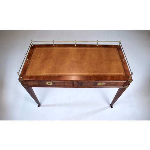 An exceptional writing desk In the French style featuring two drawers, embossed tooled leather writing surface, three-...