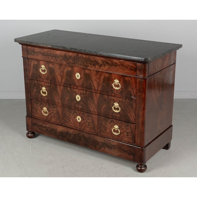 An early 19th century French Louis Philippe mahogany commode, or chest of drawers with marble top. Fine craftsmanship with...