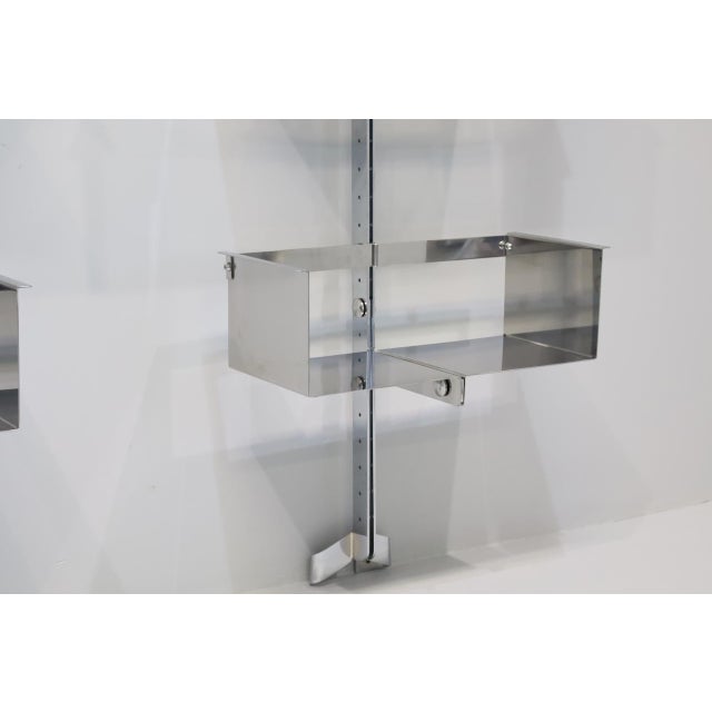 A pair of modular wall shelves designed by Vittorio Introini, produced by Saporiti, Italy, circa 1969. Stainless steel,...