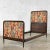 Handsome antique French carved walnut twin bed upholstered in a contemporary Asian figural fabric. It is in fabulous...