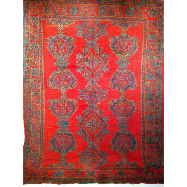 Discover a true masterpiece of early 20th-century weaving with this exceptional Vintage Turkish Oushak hand-knotted room...