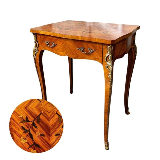 This French Louis XV-style inlaid writing table combines timeless elegance with functional design, making it an exquisite...