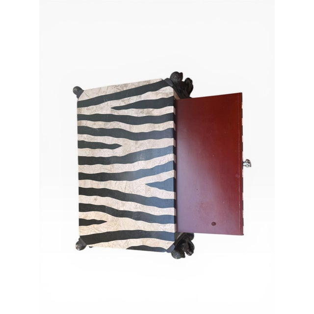 A striking tessellated stone side table attributed to Maitland-Smith, featuring a bold zebra pattern motif rendered in...