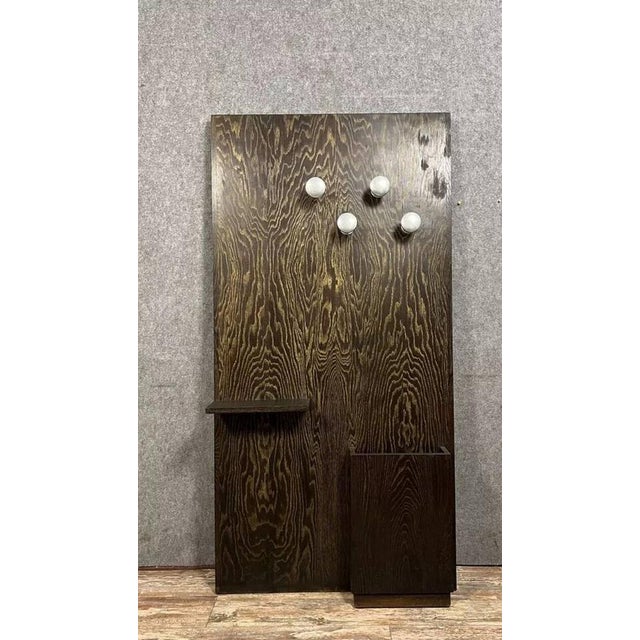 Vintage coat rack circa 1950 in figured Macassar ebony. Four silver-plated stainless steel hooks, an umbrella stand, and a...