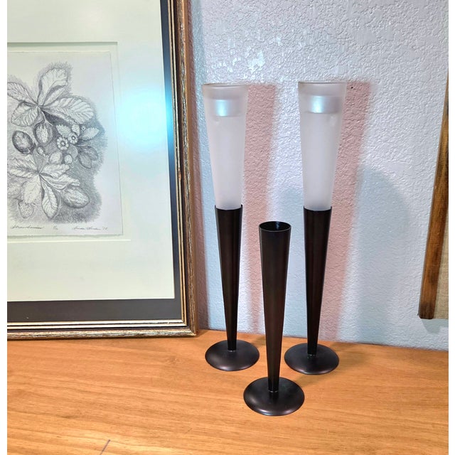 Sleek and sculptural, this set of Northern Lights tealight holders offers a refined balance of modern design and soft...