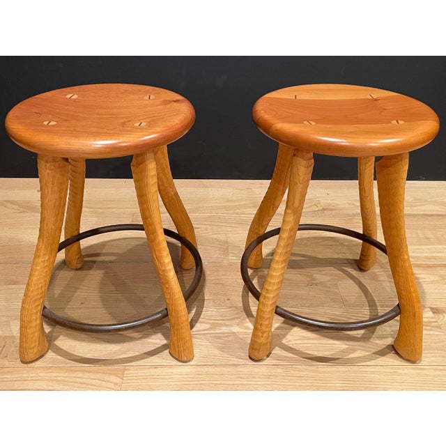Uniquely designed wood and iron stools. Farmhouse country style with ax handle form legs supported by through dowels and...