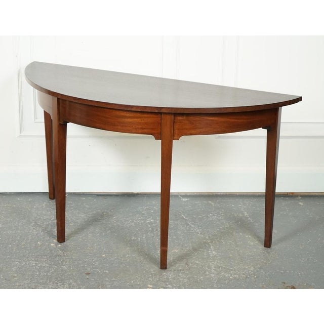 Lovely George III Demi Lune Table. This circa 1800 George III demi-lune hall side end table exudes an air of timeless...