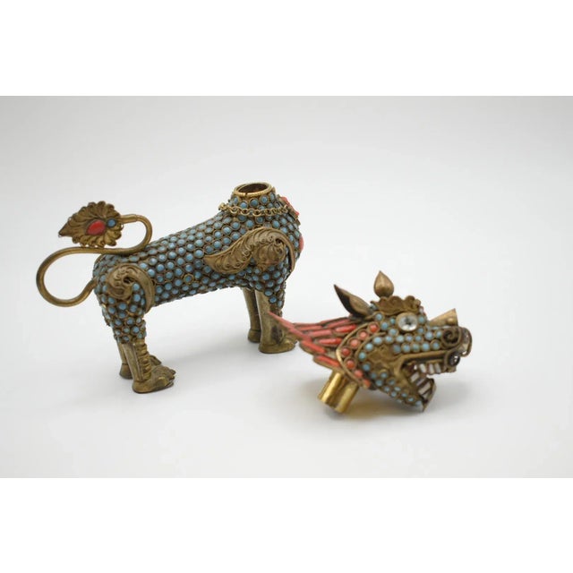 This is an Asian Filigree brass snuff bottle or incense burner depicting a foo dog standing with an open mouth. It is...