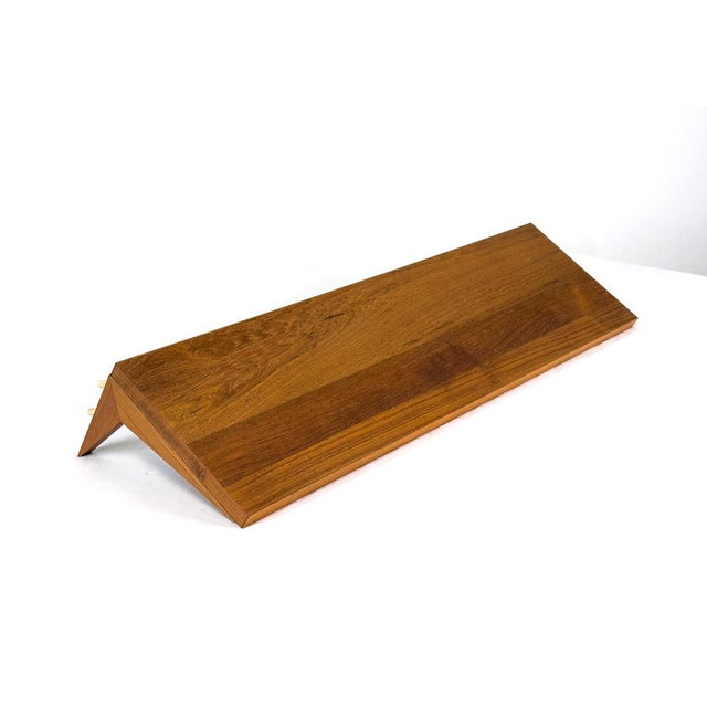 Teak shelf with two matching brackets for the "System Cado," designed by Poul Cadovius. Designed to complement existing...