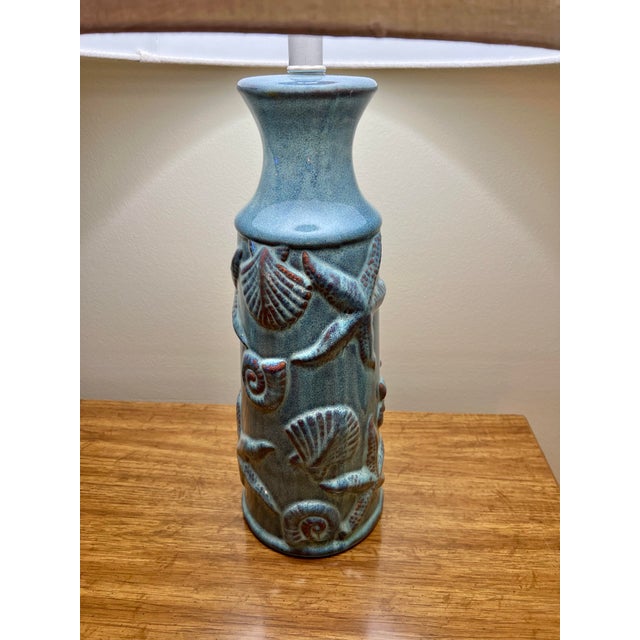 Starfish and seashells adorn this beautiful blue Nautical table lamp. Measures 20” from table to socket and base is about...